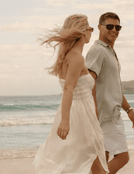 Couple on Belongil Beach outside of Elements of Byron, Byron's only beachfront Resort