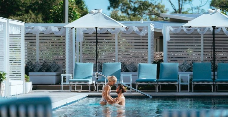 Couple cuddling in the Adults Only pool at Elements of Byron