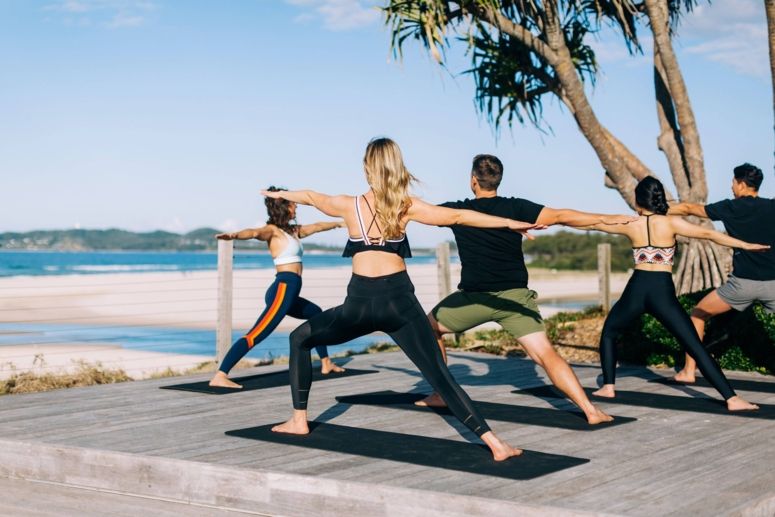 Elements of Byron guests enjoying morning beachfront yoga sessions, Byron Bay.