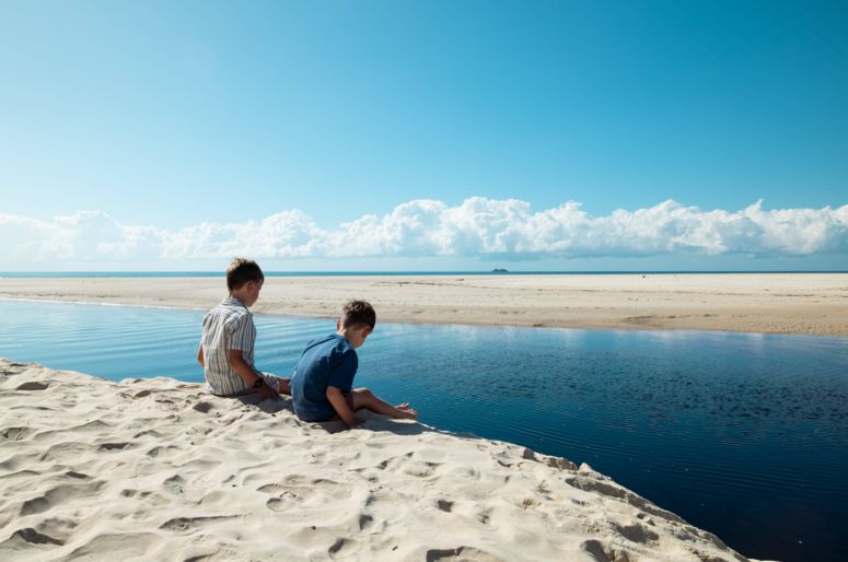 Two boys enjoying the view at Belongil Beach while staying at Elements of Byron