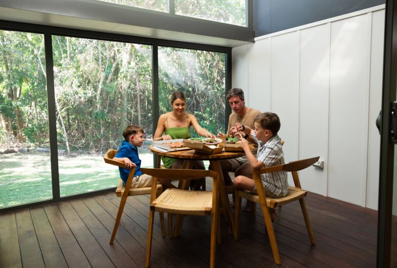 Family connecting over a shared meal in their Villa at Elements of Byron