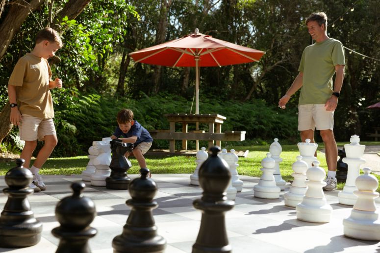 Kids with dad playing giant Bocce at Elements of Byron