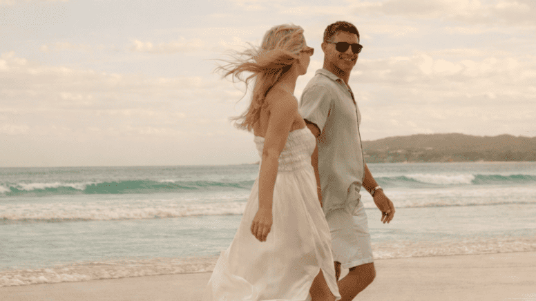 Couple on Belongil Beach outside of Elements of Byron, Byron's only beachfront Resort